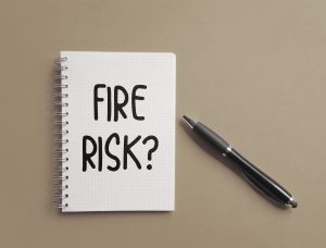 "fire risk?" message written on a notepad